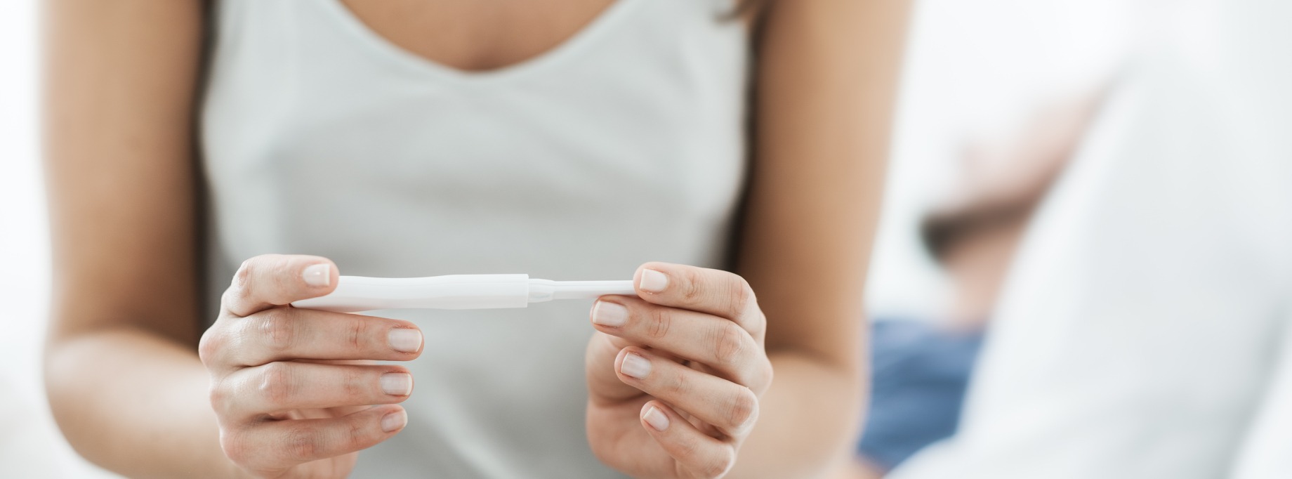 woman holding pregnancy test
